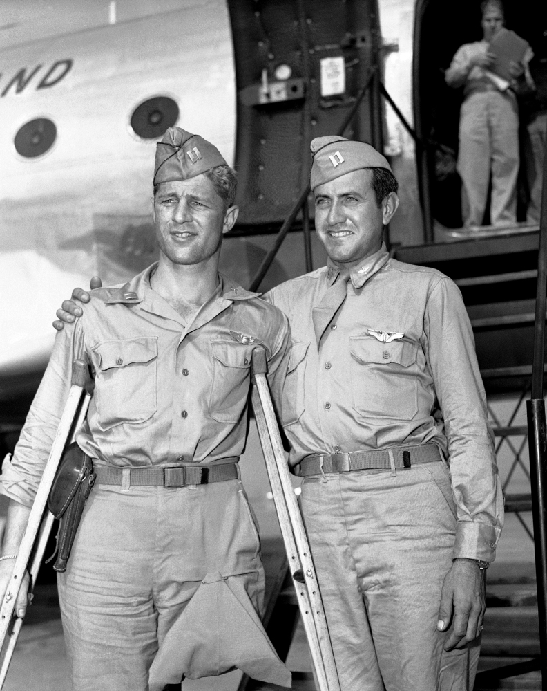 In a Oct. 3, 1945 file photo, Capt. Louis Zamperini (right), Torrence, Calif., former track star, who was adrift 47 days in Pacific after bombing mission against the Japanese and presumed dead, stands with his Pal, Capt. Fred Garrett, Riverside, Calif., upon  their arrival at Hamilton Field, Calif. Both were prisoners of war.