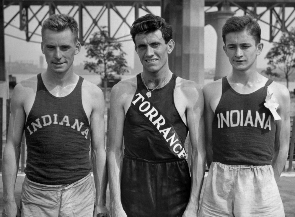 In a July 13, 1936 file photo, Don Lash of Indiana, left, Louis Zamperini of Los Angeles, center, and Thomas Deckard of Indiana, who  represented the United States in the Olympic Games in the 5,000 meter team, at the Olympic tryouts in New York. Zamperini, a U.S. Olympic distance runner and World War II hero, has died at 97.