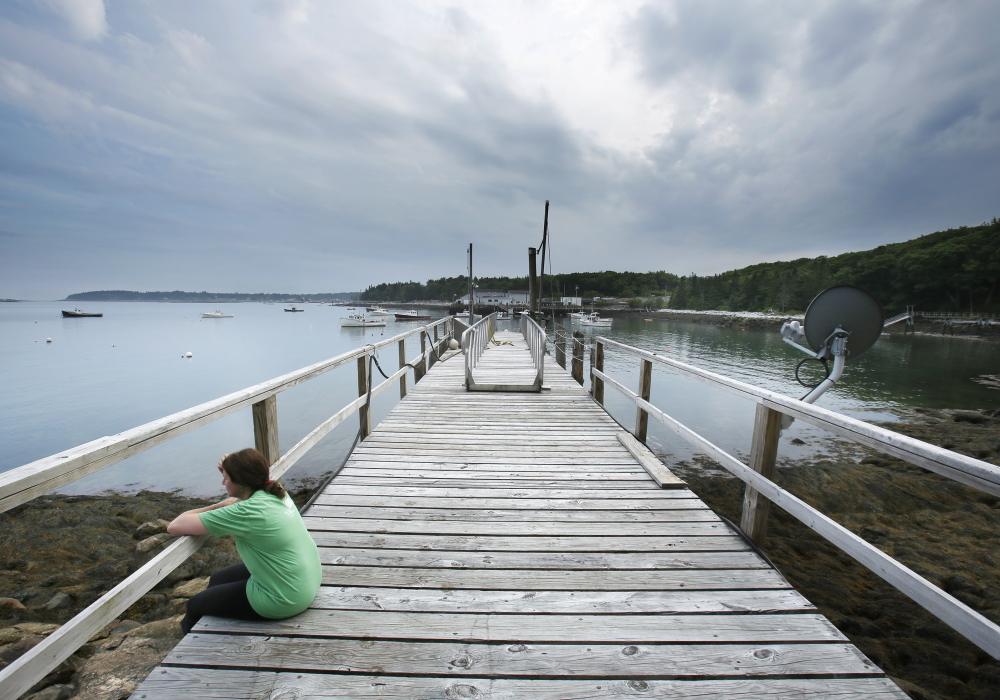 After a run, writer Mary Pols rests on a dock in Tenants Harbor that is available with the Yurt she was staying in overnight. Gregory Rec/Staff Photographer
