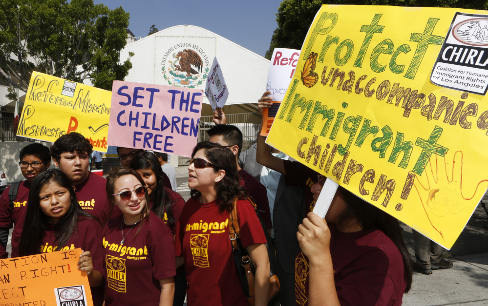 Activists with the Coalition for Humane Immigrant Rights of Los Angeles call for support for migrant children and families crossing Mexico’s territory during a protest outside the Mexican consulate in Los Angeles on Thursday. The demonstration comes as President Obama faces mounting calls from Republicans to visit the U.S.-Mexico border.