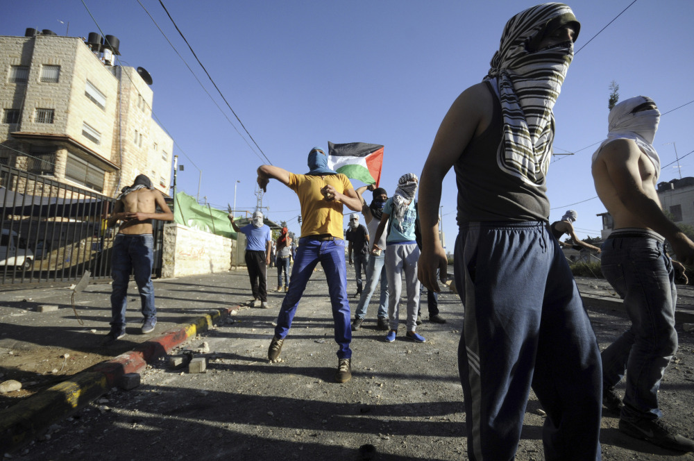 Palestinians throw stones during clashes with Israeli security forces in Jerusalem on Thursday. The violence erupted Wednesday after 16-year-old Palestinian Mohammed Abu Khdeir was abducted and killed. His family believes extremist Israelis killed him in revenge for the deaths of three Israeli teenagers.