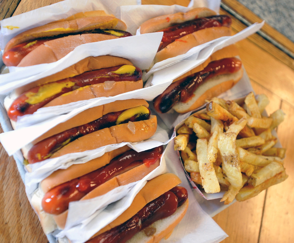 Hot dogs and fries are served at Bolley’s Famous Franks on College Avenue in Waterville on Thursday.