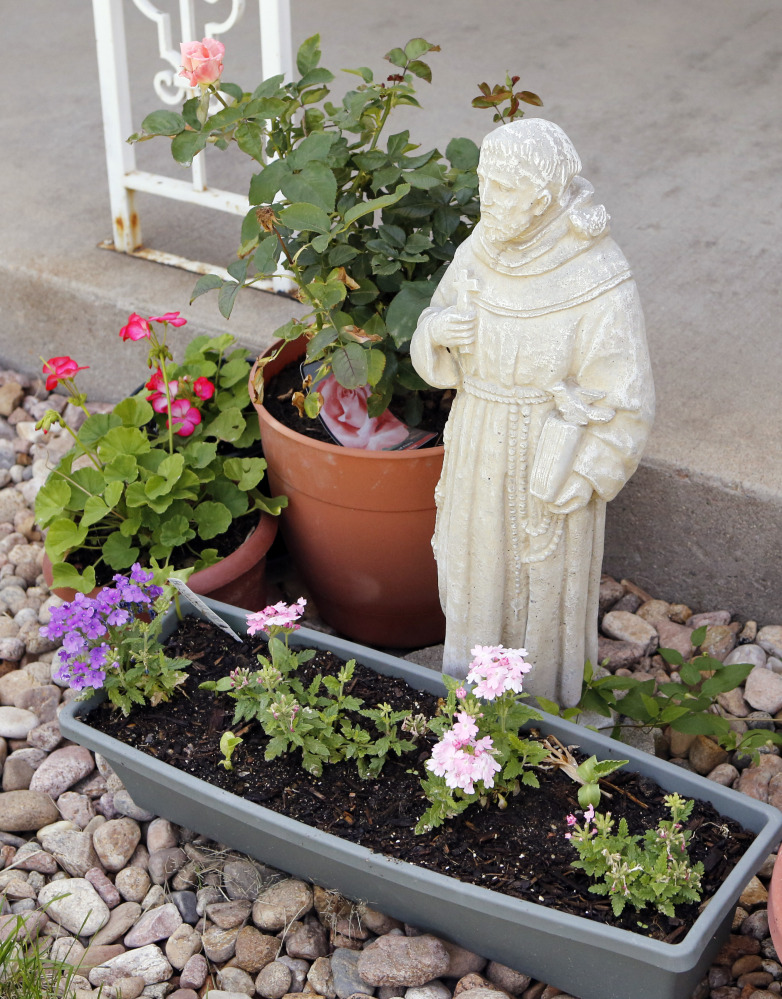 A statue of St. Francis stands outside the home of Ana Maria and John Conley in Arvada, Colo., where their daughter Shannon Maureen Conley, 19, lived until her arrest by the FBI in April. The teen is charged with conspiring to aid terrorists.