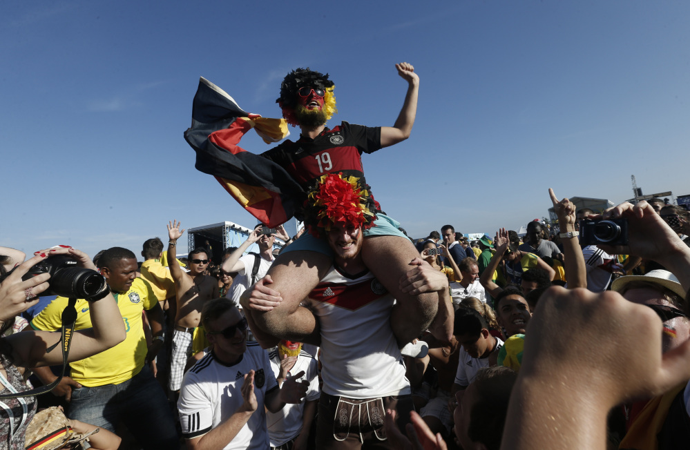 Germany soccer fans celebrate their team’s victory inside the FIFA Fan Fest area, where the World Cup quarterfinal match between Germany and France was broadcast live, on Copacabana beach, in Rio de Janeiro.