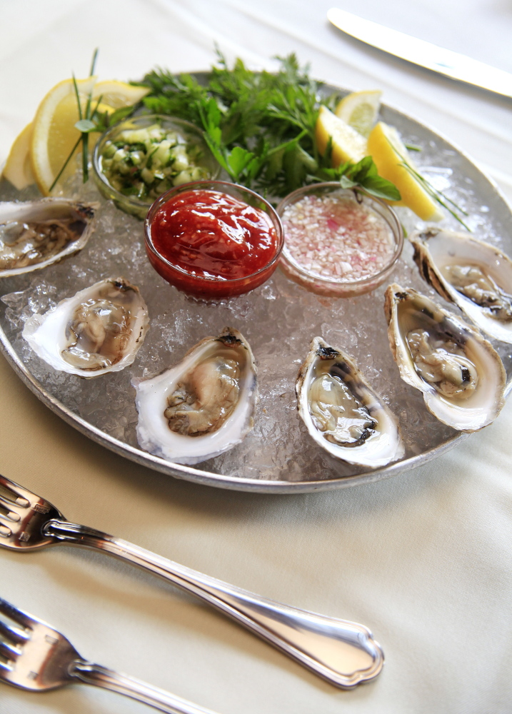 Anneke Jans’ Little Bay oysters appetizer is served with a trio of sauces. 