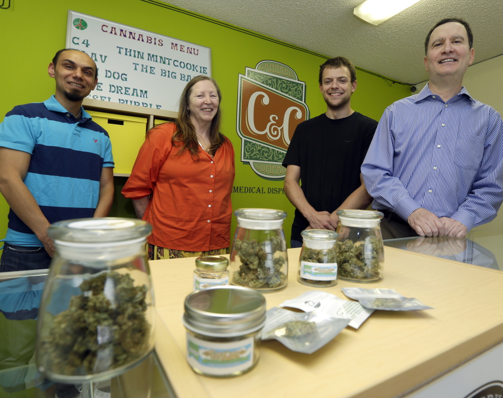 Pete O’Neil, right, stands with employees in his medical marijuana dispensary in Seattle. After he struck out in the pot-shop license lottery, he turned to Plan B – the dispensary.