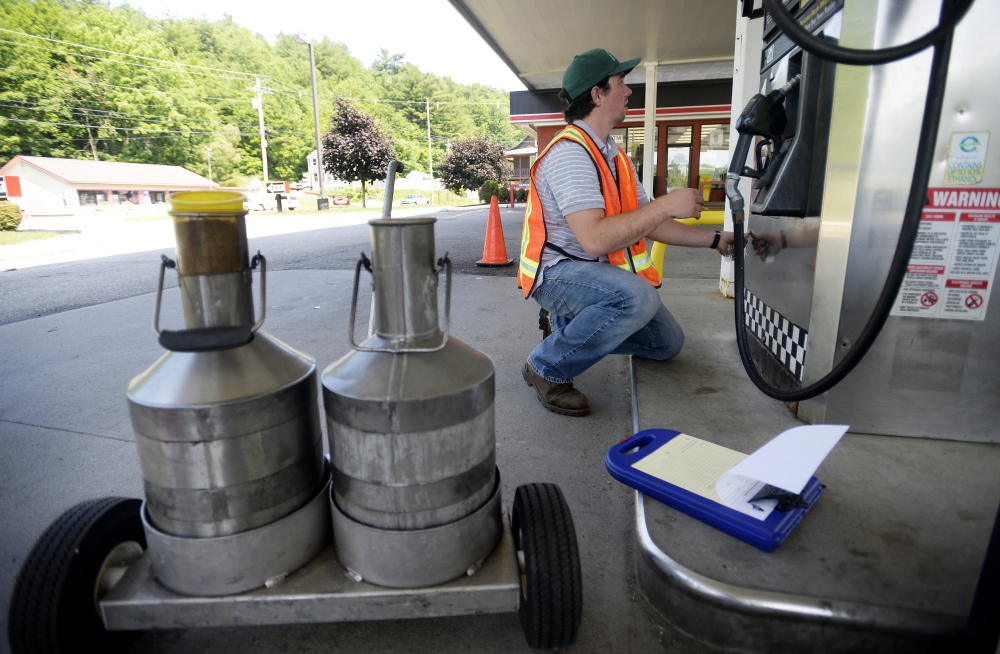 Michael Picard, a consumer protection inspector with the Maine Department of Agriculture, Conservation and Forestry, inspects pumps at J&S Oil Express Stop in Augusta last month.