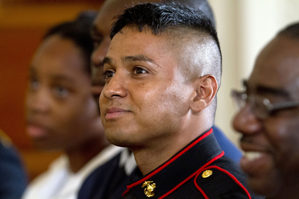 Marine Pfc. Oscar Gonzalez, who was born in Guatemala, listens as President Obama speaks during a naturalization ceremony for active duty service members, including Gonzalez, and civilians on Friday at the White House in Washington.