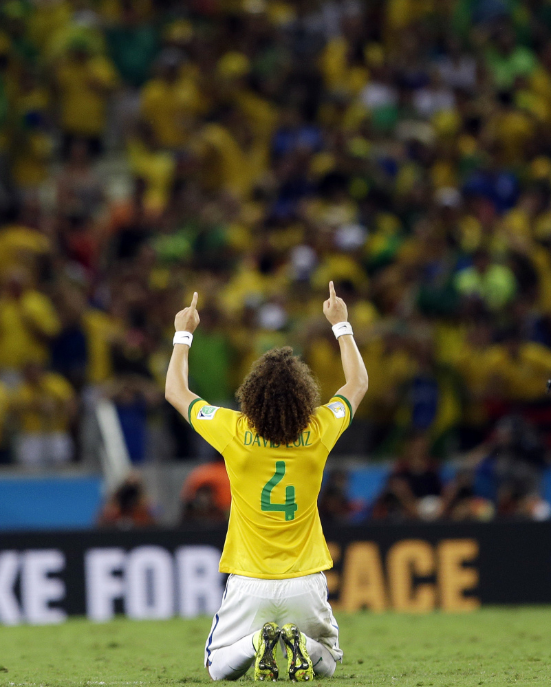 Brazil's David Luiz celebrates after Brazil's 2-1 victory to advance to the semifinals during the World Cup quarterfinal soccer match between Brazil and Colombia at the Arena Castelao in Fortaleza, Brazil, on Friday. Luiz scored his side's second and decisive goal. The Associated Press