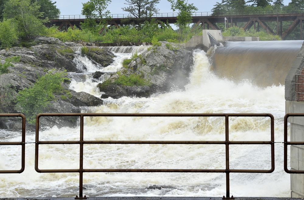 Raging water from the passing storm Friday night rush over the Great Falls in Lewiston.