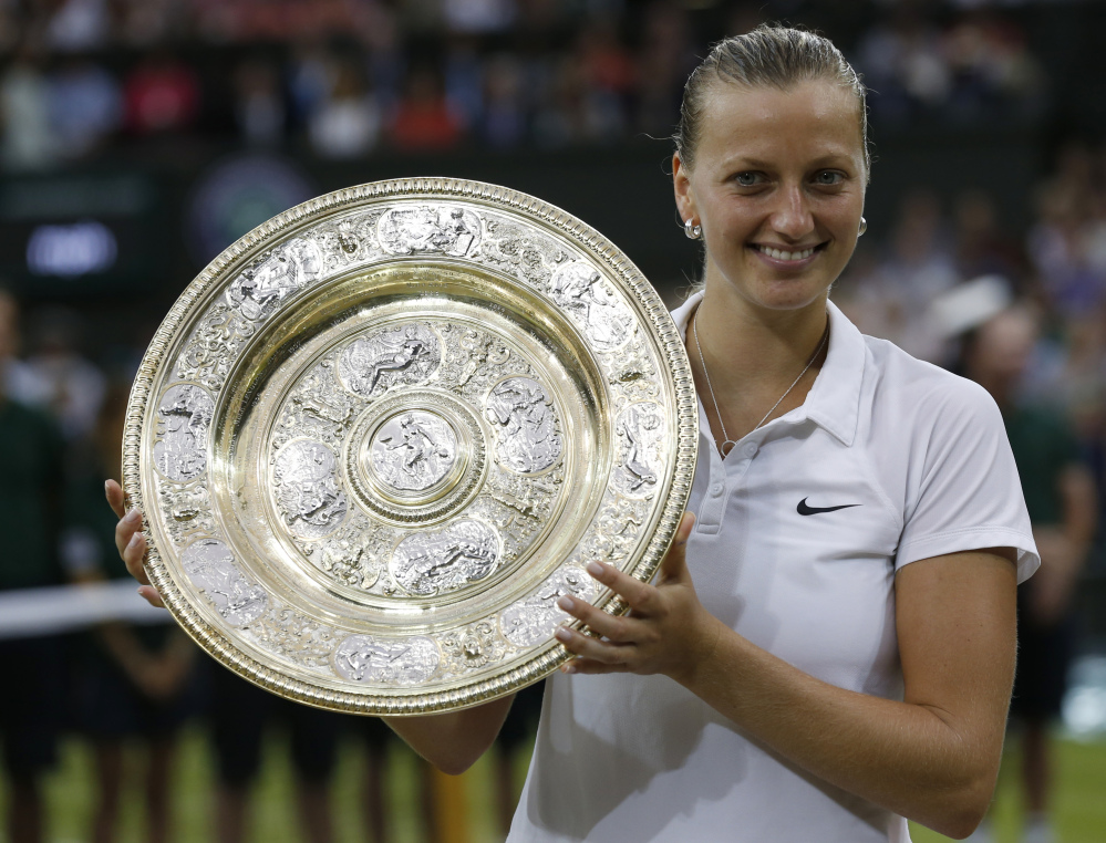 Petra Kvitova holds the  trophy after winning the women’s singles final against Eugenie Bouchard on Saturday in Wimbledon.