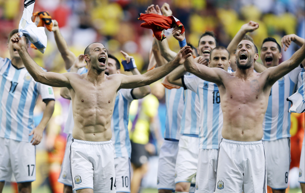 Argentina’s Javier Mascherano, left, and his teammates celebrate following their 1-0 victory over Belgium to advance to the World Cup semifinals at the Estadio Nacional in Brasilia, Brazil, on Saturday.