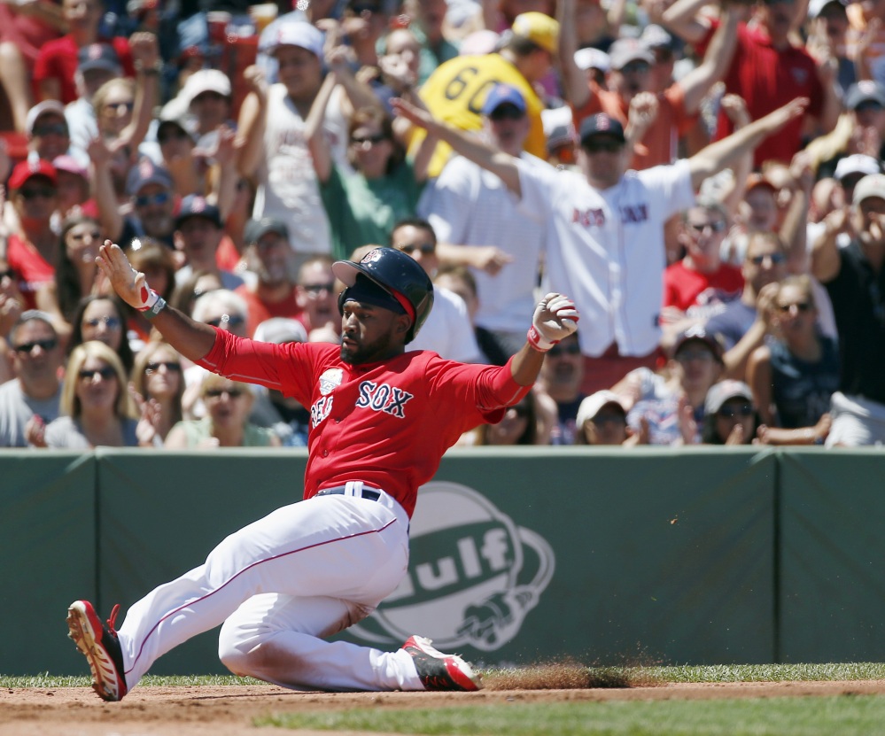 Jackie Bradley Jr. scores on an error by Baltimore’s Steve Pearce in the second inning of the first game of a doubleheader Saturday in Boston. The Red Sox won the first game, 3-2.