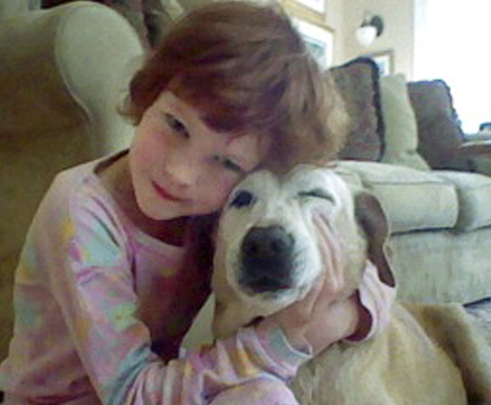 Catherine Violet Hubbard hugs her dog Sammy at home in Newtown, Conn., in 2012. Despite her death in the mass shooting at Sandy Hook Elementary School on Dec. 14, 2012, Catherine’s dream of helping animals is close to becoming a reality. By early August, the state is expected to finalize transferring 34 acres of land for the new Catherine Violet Hubbard Animal Sanctuary.