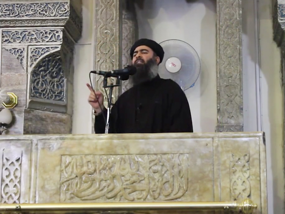 This image made from video posted on a militant website Saturday, which has been authenticated based on its contents and other AP reporting, purports to show the leader of the Islamic State group, Abu Bakr al-Baghdadi, delivering a sermon at a mosque in Iraq. The Associated Press