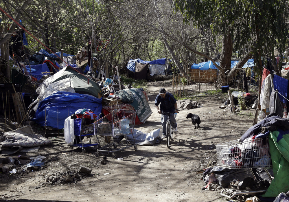 Tents are set up along a pathway in the Jungle, a homeless encampment in San Jose, Calif. Residents of the Jungle are well aware of the affluent world that lies just outside its borders in Silicon Valley, which is home to Apple, Google, Facebook and more tech giants.