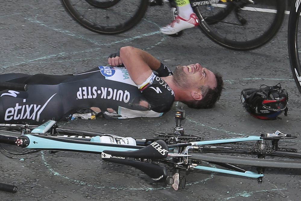 Britain’s sprinter Mark Cavendish grimaces after he crashed late in the first stage of the Tour de France on Saturday. Cavendish pulled out of the race Sunday with an injured shoulder that may require surgery.