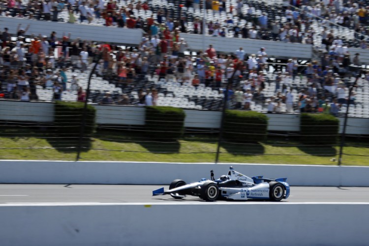 Juan Pablo Montoya, of Colombia, celebrates as he drives down the front stretch to win the Pocono IndyCar 500 auto race on Sunday, in Long Pond, Pa.