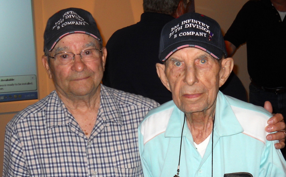 Age won’t make Wilfred “Spike” Mailloux, left, forget his debt to John Sidur, who came to his aid amidst the fierce fighting between U.S. and Japanese forces on the strategically critical island of Saipan. Mailloux and Sidur attended the 70th anniversary of the battle at the New York State Military Museum on June 7.