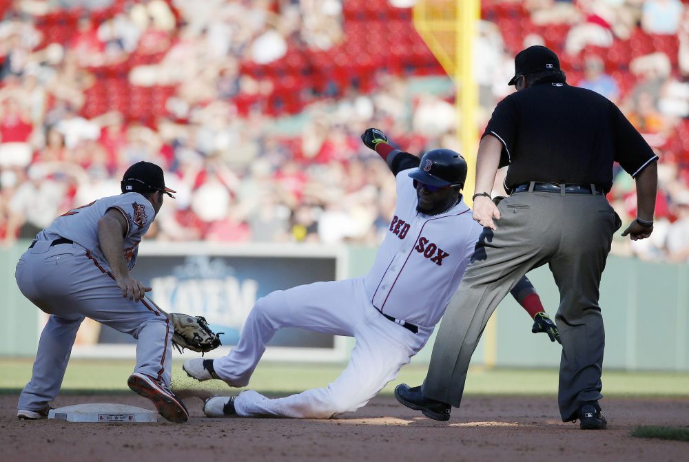 Baltimore Orioles’ J.J. Hardy, left, tags Boston Red Sox’s David Ortiz, right, at second base after Oritz tried to reach on a single in the twelfth inning of a baseball game in Boston, Sunday.