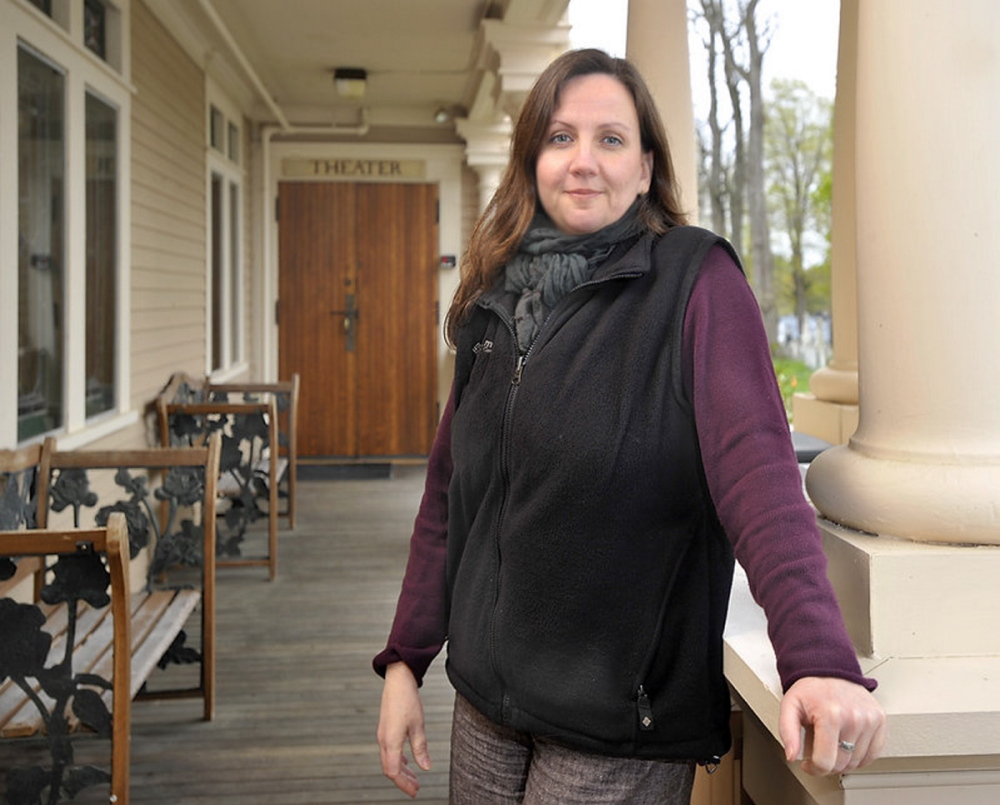 Dawn McAndrews, producing artistic director of the Theater at Monmouth, stands on the veranda entrance to the theater.