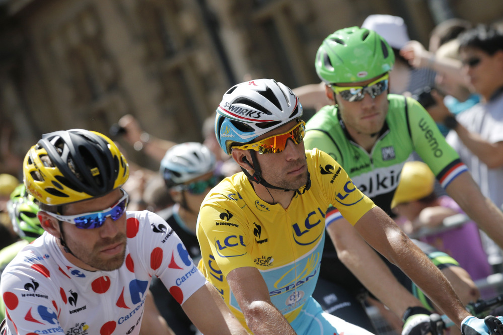France’s Cyril Lemoine, wearing the best climber’s dotted jersey, and Italy’s Vincenzo Nibalia, wearing the overall leader’s yellow jersey, ride in the pack during the ceremonial procession prior to the start of the third stage of the Tour de France cycling race in England on Monday.