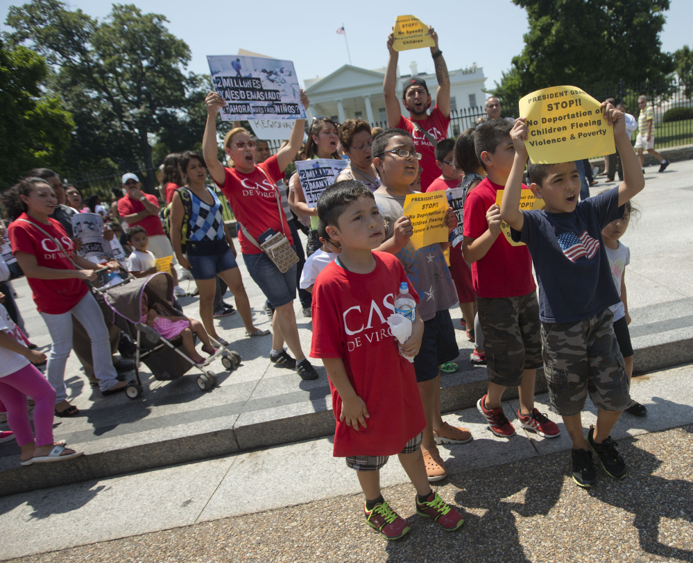 Demonstrators march in front of the White House on Monday after a news conference with immigrant families and children’s advocates responding to President Obama’s response to the crisis of unaccompanied children and families illegally entering the U.S.