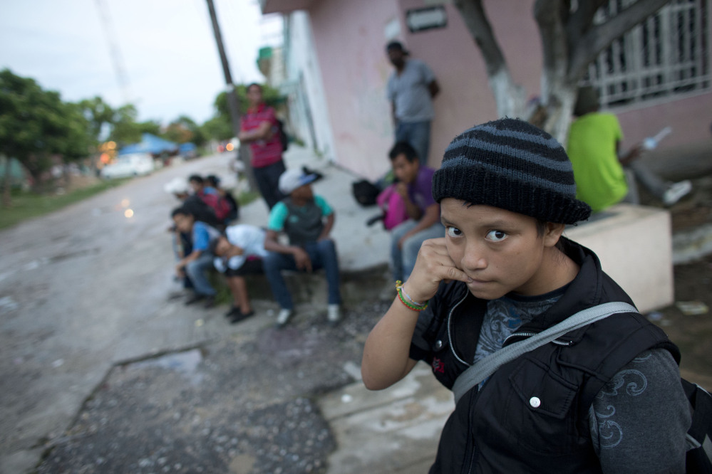 A 14-year-old Guatemalan girl traveling alone in June waits for a northbound freight train along with other Central American migrants in Arriaga, Chiapas state, Mexico.