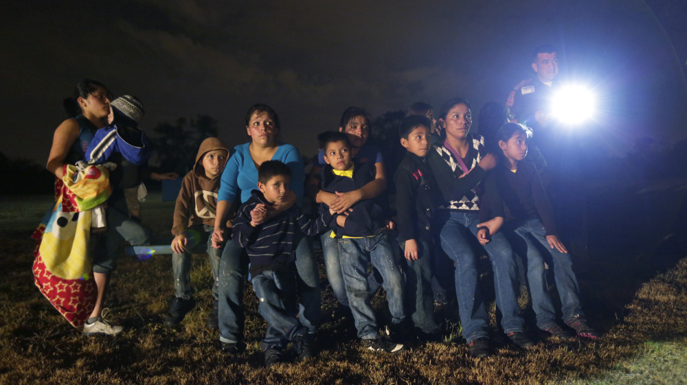 A group of immigrants from Honduras and El Salvador who crossed the U.S.-Mexico border illegally are stopped in Granjeno, Texas, last month. In the first week of June alone, agents arrested more than 2,800 people in this area.