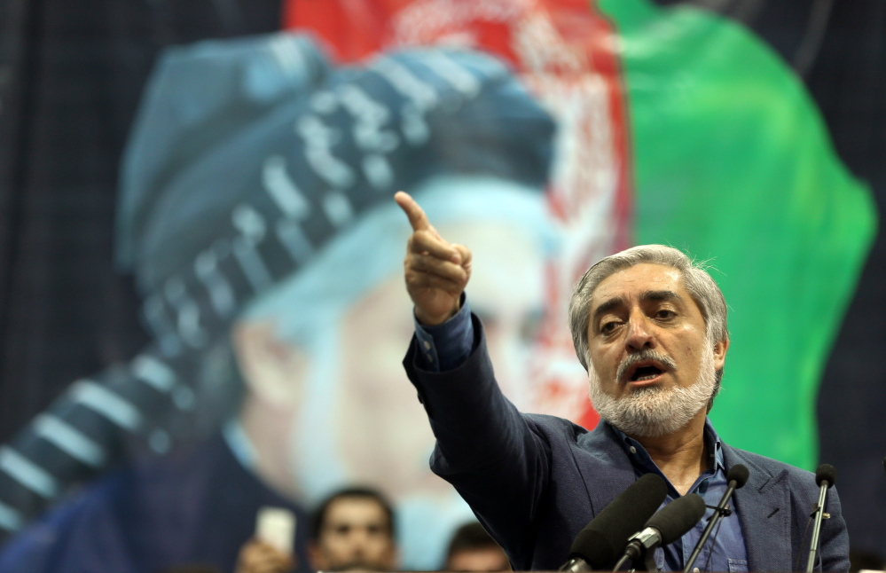 Afghan presidential candidate Abdullah Abdullah speaks during a gathering of his supporters in Kabul, Afghanistan, Tuesday, July 8, 2014. Abdullah says he received calls from President Barack Obama and U.S. Secretary of State John Kerry after he refused to accept the preliminary result of the vote citing fraud. Abdullah told his supporters the results of the election were fraudulent but asked them to give him a few more days to negotiate. (AP Photo/Massoud Hossaini)