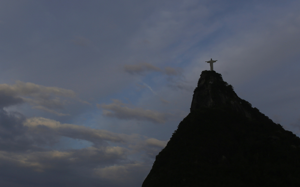 Christ the Redeemer statue is silhouetted against the sky as Wednesday dawned in Rio de Janeiro, Brazil, a day after the national soccer team’s brutal and humiliating 7-1 World Cup defeat to Germany.