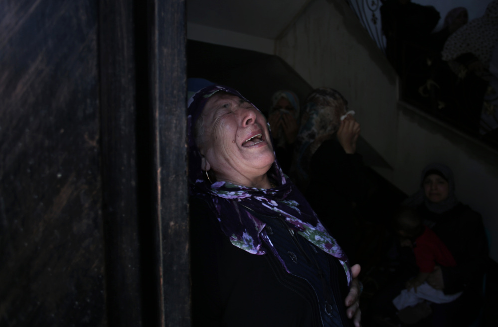 A Palestinian relative of the five members of the Hamad family who were killed in an Israeli missile strike late Tuesday grieves in the family house during their funeral in town of Beit Hanoun, northern Gaza Strip, on Wednesday.