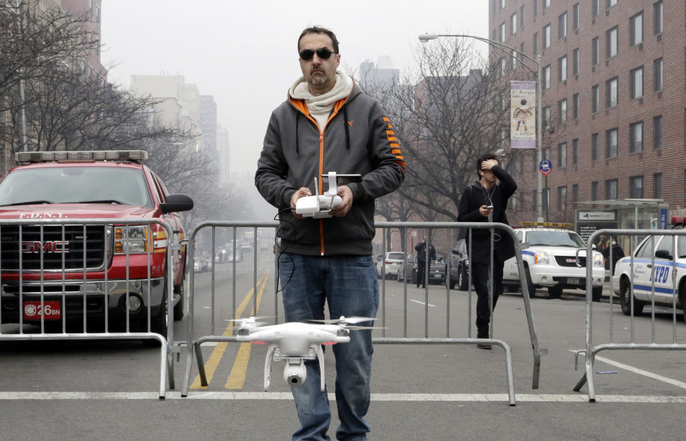 Brian Wilson launches a small drone equipped with a video camera to fly over the scene of an explosion in March that leveled two apartment buildings in East Harlem.