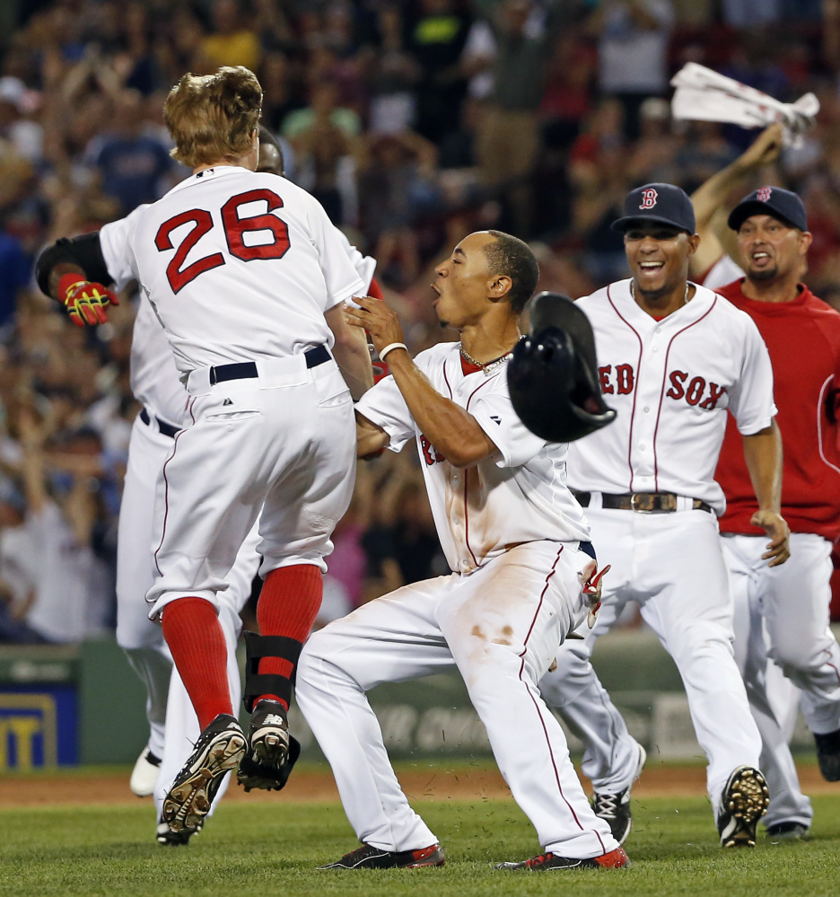 Brock Holt (26) celebrates with teammates including Mookie Betts, front center, and Xander Bogaerts after hitting an RBI single to give the Red Sox a 5-4 win over the Chicago White Sox on Wednesday night.
