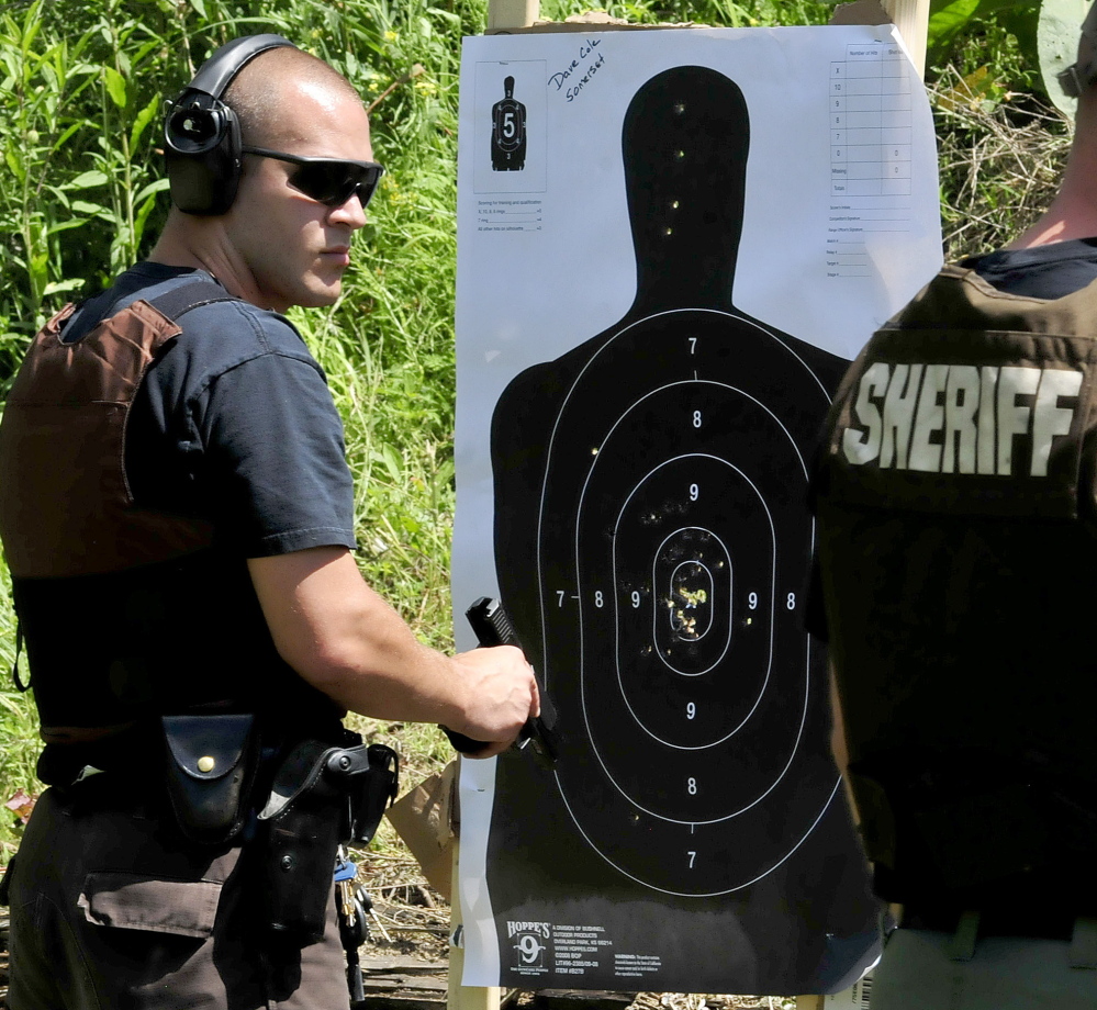 Somerset County Sheriff’s Department Deputy David Cole checks his paper target after firing during the Shawn Donahue Memorial “Shooting Star” competition in Winslow.