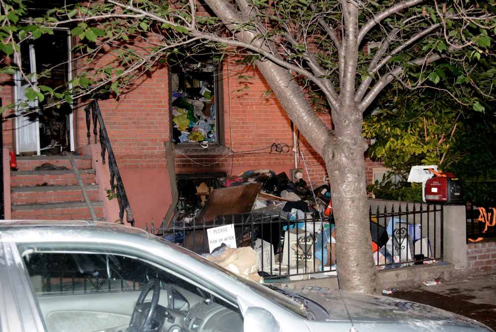 Debris is piled up after a fire broke out in the basement in Jersey City, N.J., rowhouse, killing a 32-year-old Stephanie Britton. Firefighters had a hard time getting to Britton, who died on the second floor because of an extreme amount of clutter, according to Jersey City Fire Chief Darren Rivers.