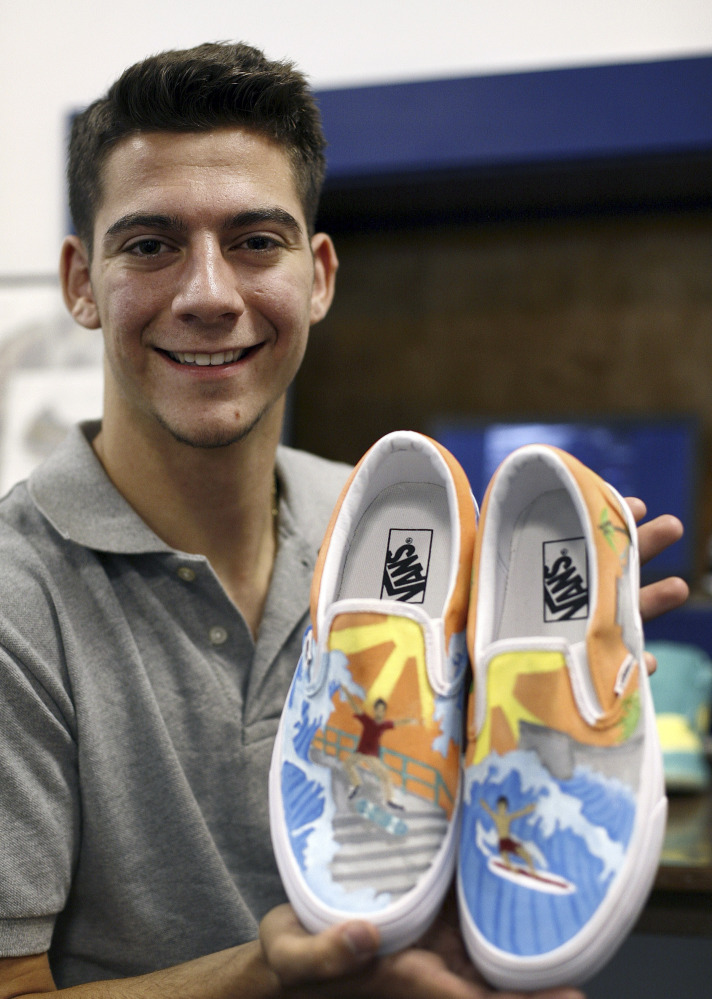 Christian Fuda, 17, of Hull, Mass., displays some of the custom-painted footwear he creates and sells.