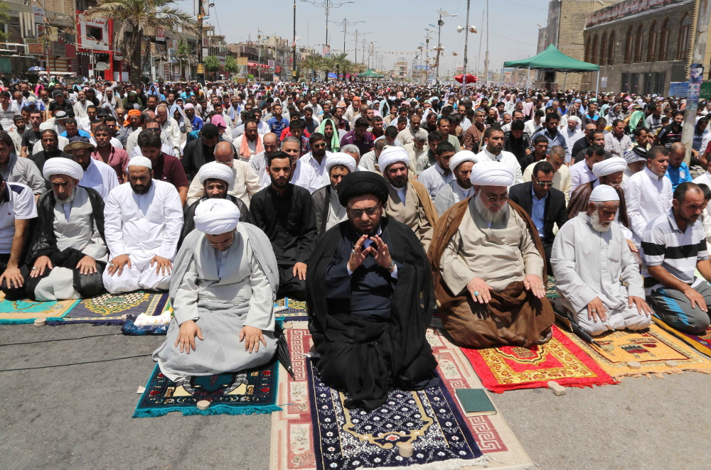 Shiites attend Friday prayers in Baghdad’s Sadr City. Meanwhile, a suicide bomber blew himself up at a checkpoint near Kirkuk, killing 13 people and wounding 23.