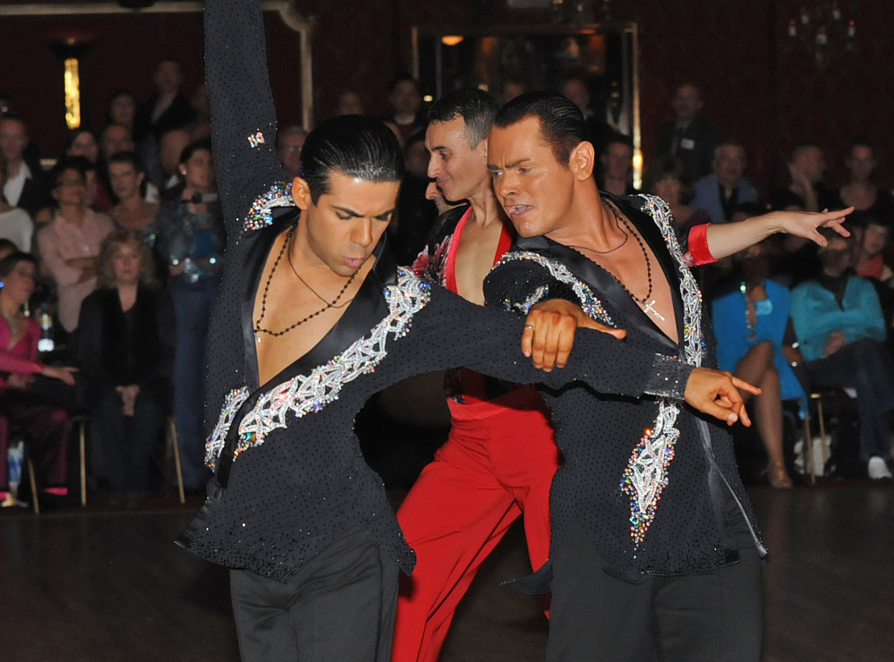 Sergio Brilhante, left, and Jonathan Morrison take part in a ballroom dancing competition. The governing body of ballroom dancing in Britain has stirred controversy by proposing to ban same-sex couples from competitions.