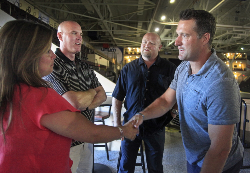 Mary Mathieson of Gorham greets former Portland Pirates defenseman Ken Klee, far right, while her husband, defenseman Jim Mathieson, second from left, looks on with another former teammate, Kerry Clark. Twelve members of the 1993-94 Calder Cup champions gathered Friday for a reunion at Cross Insurance Arena.