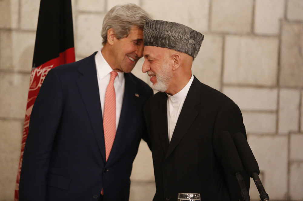 Afghanistan President Hamid Karzai shares a light moment with U.S. Secretary of State John Kerry in Kabul on Saturday.