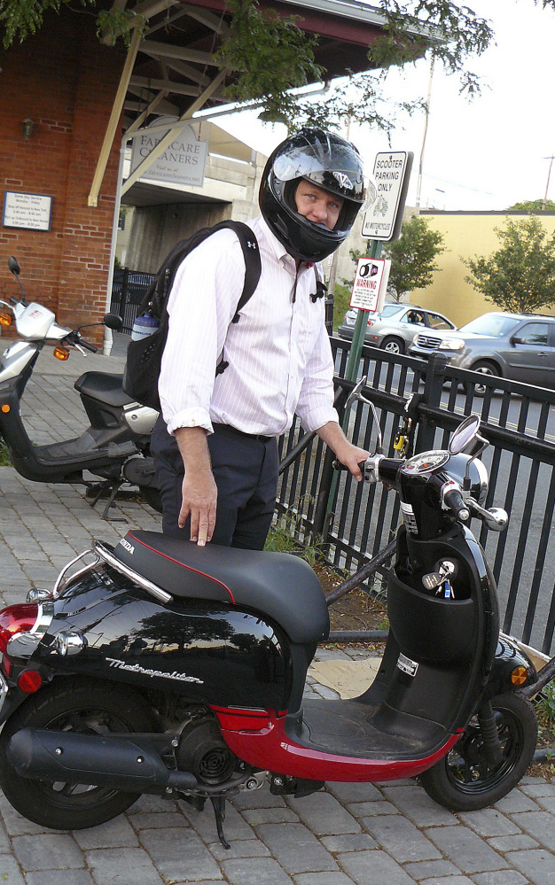 Zach Chapman prepares to jump on his scooter for his daily ride home from the Fairfield Center train station in Fairfield, Conn. Chapman became a scooter commuter because he said that riding his scooter is better for the environment than driving a car.