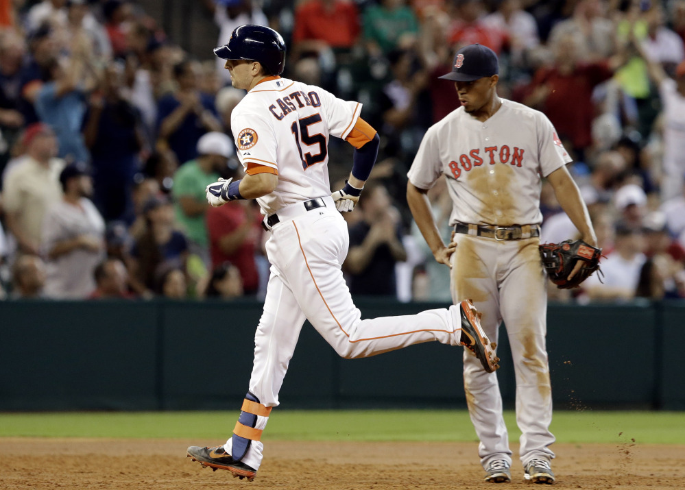 Astros catcher Jason Castro rounds the bases in front of Red Sox third baseman Xander Bogaerts after hitting a two-run home run in the third inning Saturday in Houston.