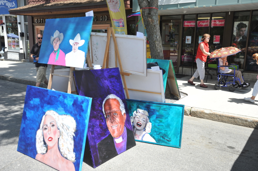 Artwork stands on display on Main Street in Waterville during the art walk co-hosted by the Maine International Film Festival on Saturday.