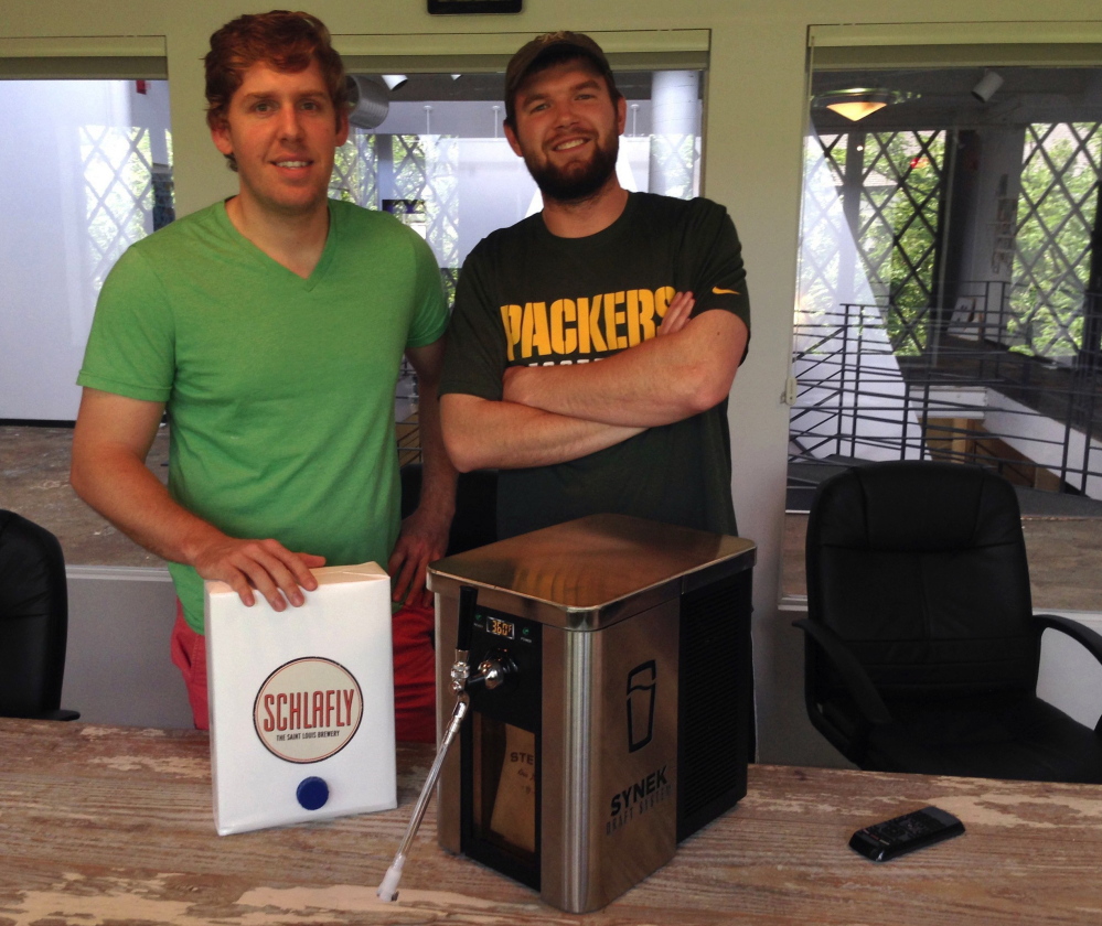 Synek’s co-founder Steve Young, left, and strategic director Michael Werner with their beer dispenser, which is the subject of a successful Kickstarter campaign that has seen them raise more than $450,000 for development, manufacturing and marketing expenses.