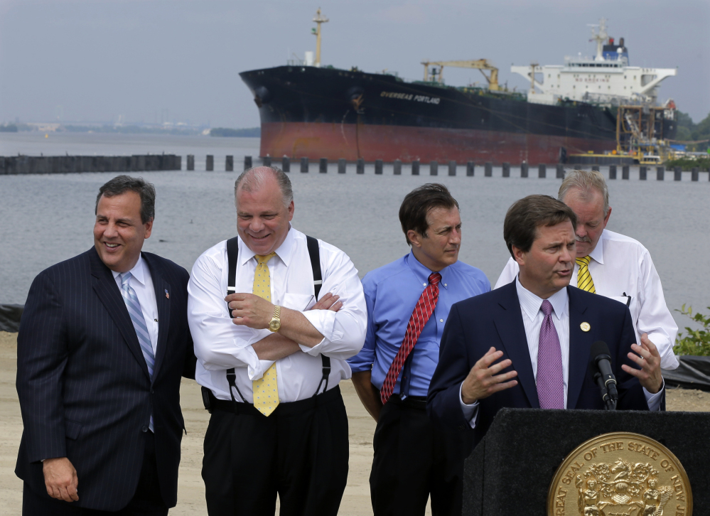 New Jersey Gov. Chris Christie, left, shares a laugh with state Senate President Stephen Sweeney as they listen to state Sen. Donald Norcross in Paulsboro, N.J. Christie has been unusually silent on some of the most hot-button national issues recently.

The Associated Press