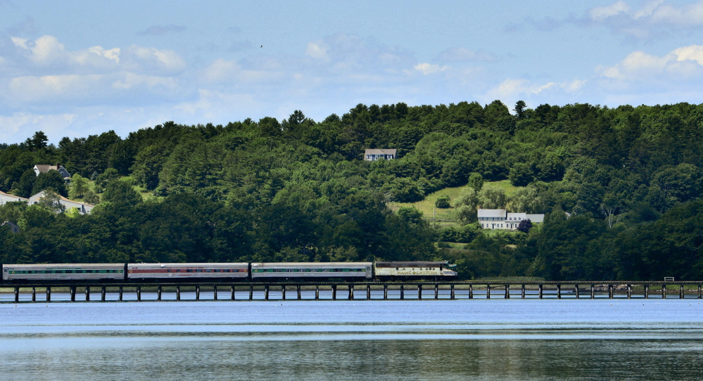 A Maine Eastern Railroad train crosses Friday over the Sheepscot River outside of Wiscasset, which is now the hub of a new train service.