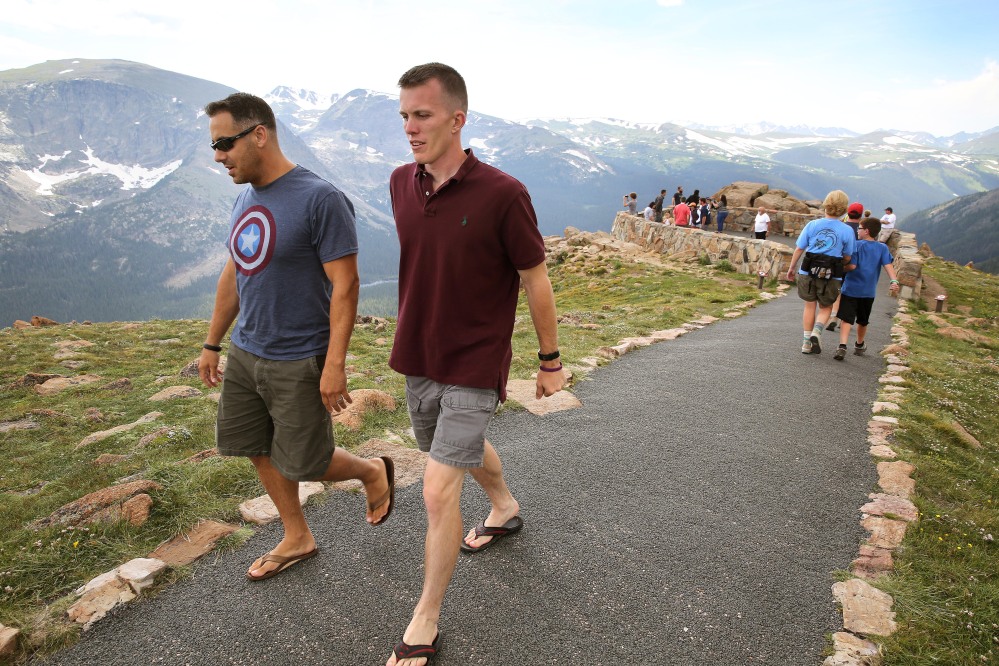 Visitors walk a short trail at a scenic overlook off Trail Ridge Road at Rocky Mountain National Park, west of Estes Park, Colo., on Monday. Lightning killed two people last weekend just miles apart in the popular park, where summer storms can close in quickly with deadly results.