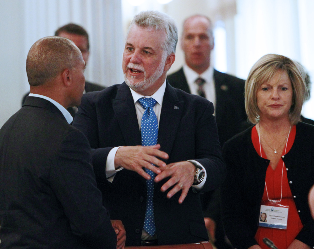 Premier Philippe Couillard of Quebec speaks with Massachusetts Gov. Deval Patrick at the New England Governors and Eastern Canadian Premiers 38th annual conference Monday in Bretton Woods, N.H.