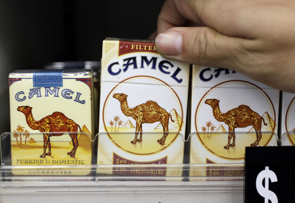 Camel cigarettes, a Reynolds American product, are on display at a liquor store in Palo Alto, Calif. The Associated Press